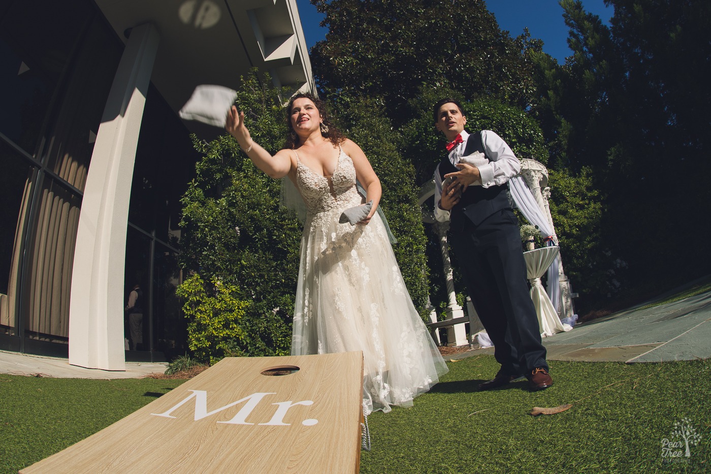 Atlanta wedding couple playing cornhole outside of The Atrium