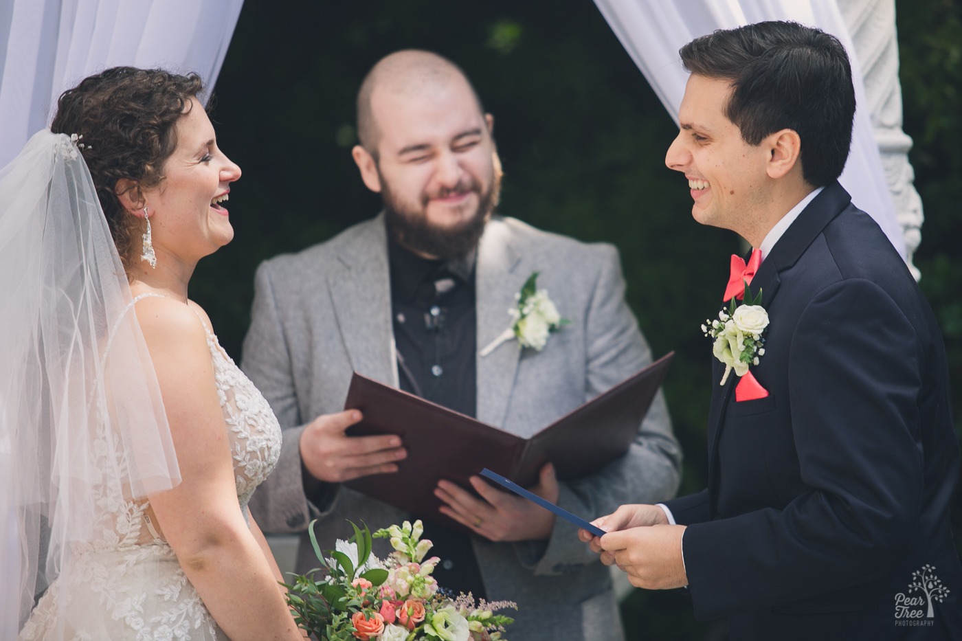 Bride and groom laughing during their Atlanta wedding ceremony at The Atrium