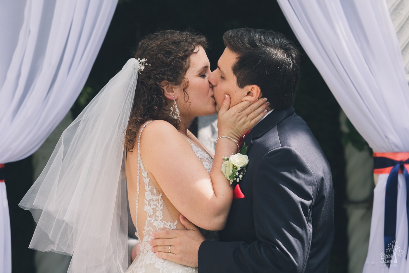 Bride and groom kissing at the end of their wedding ceremony at The Atrium.