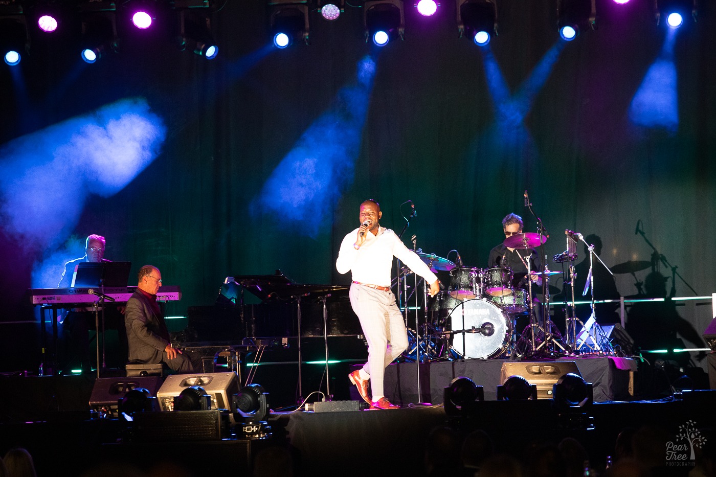 Broadway performer singing on stage at Atlanta Mercedes Benz stadium