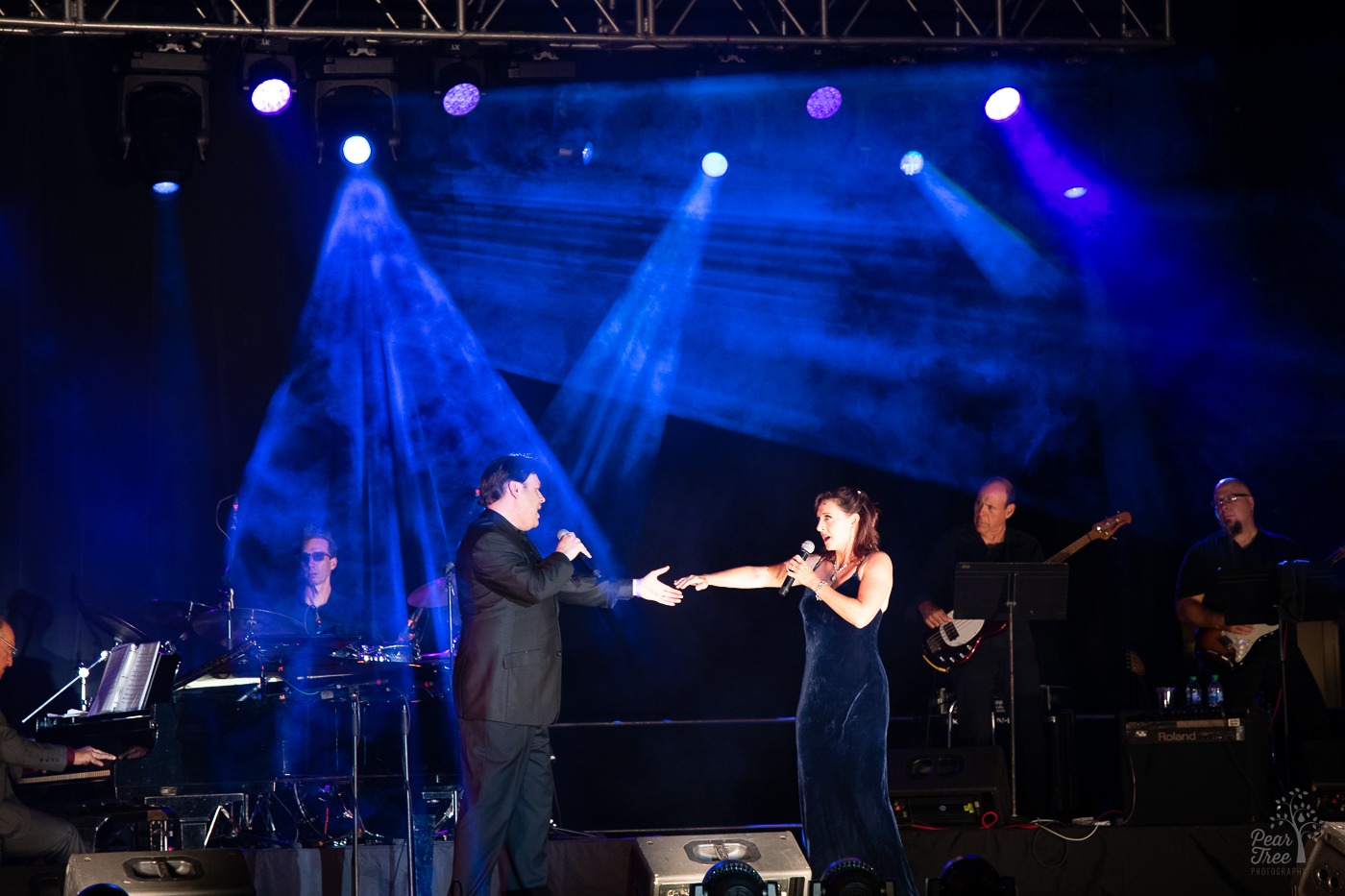 Rita Harvey and Richard Todd Adams extending arms to hold hands. They are performing at 2021 Night of Broadway Stars inside Atlanta's Mercedes Benz stadium for Covenant House Georgia supporters