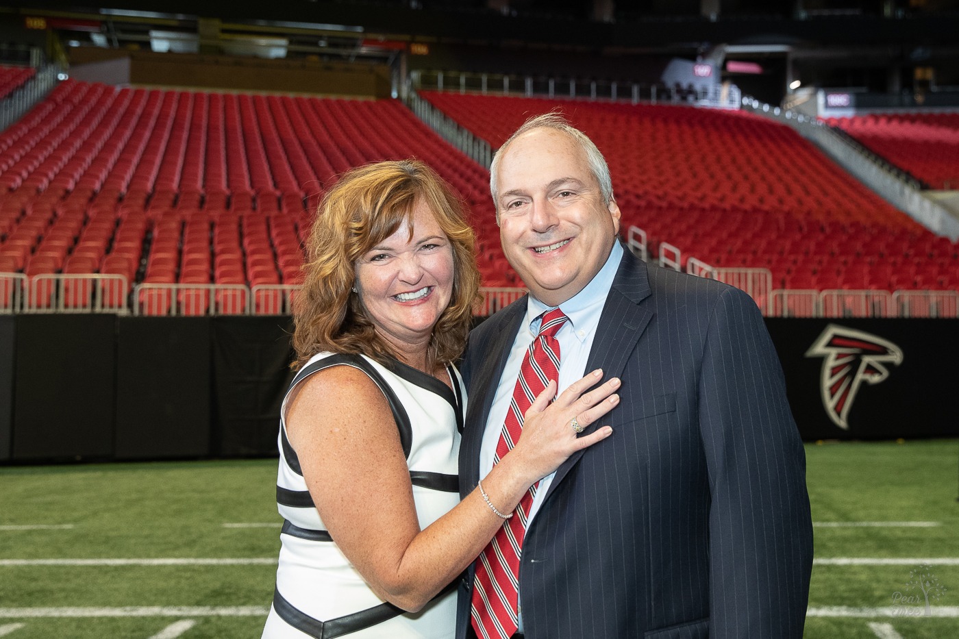 Kimberly Euston standing on the Mercedes Benz stadium field with her husband before the 2021 Night of Broadway Stars