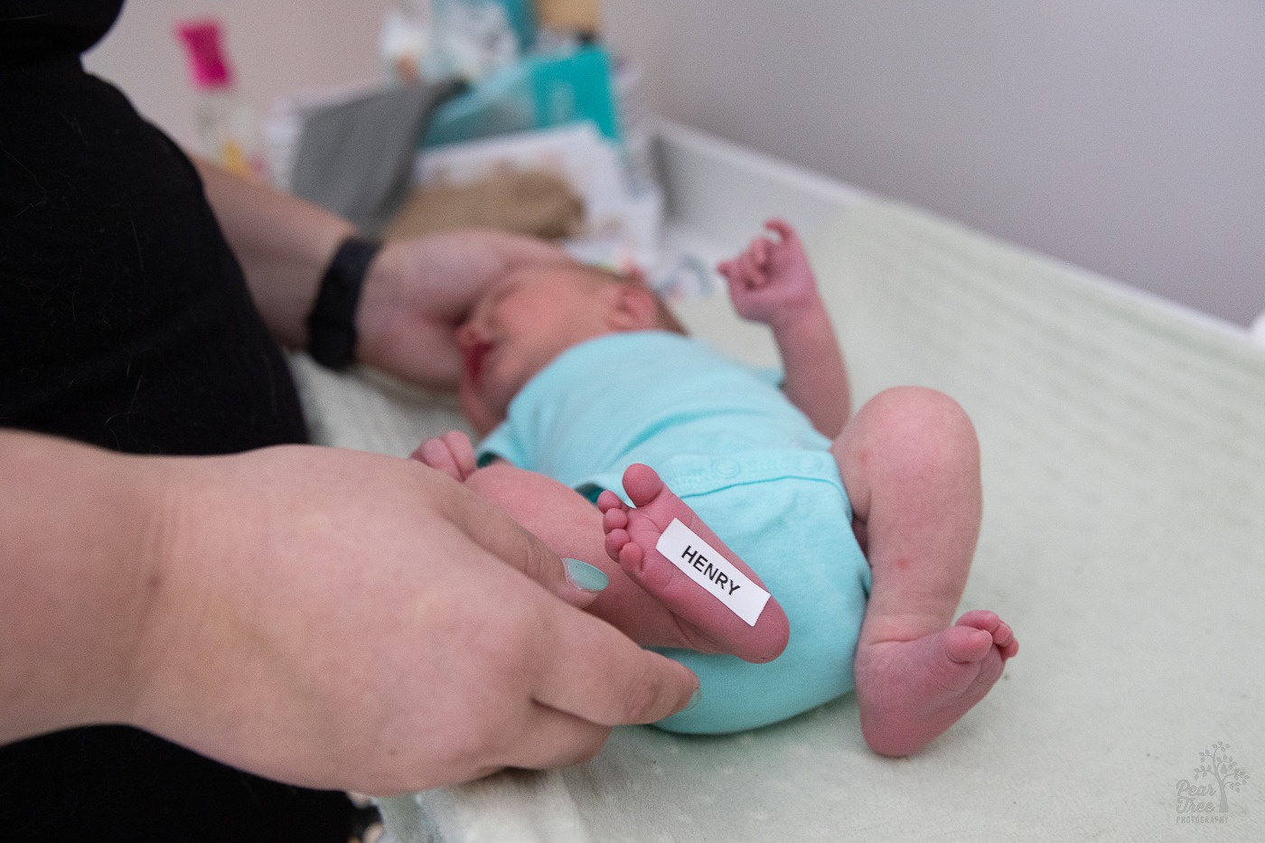 Newborn baby with his name on a label stuck to his foot