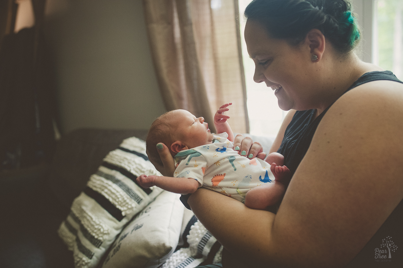 Mom holding her baby boy during her newborn photography session