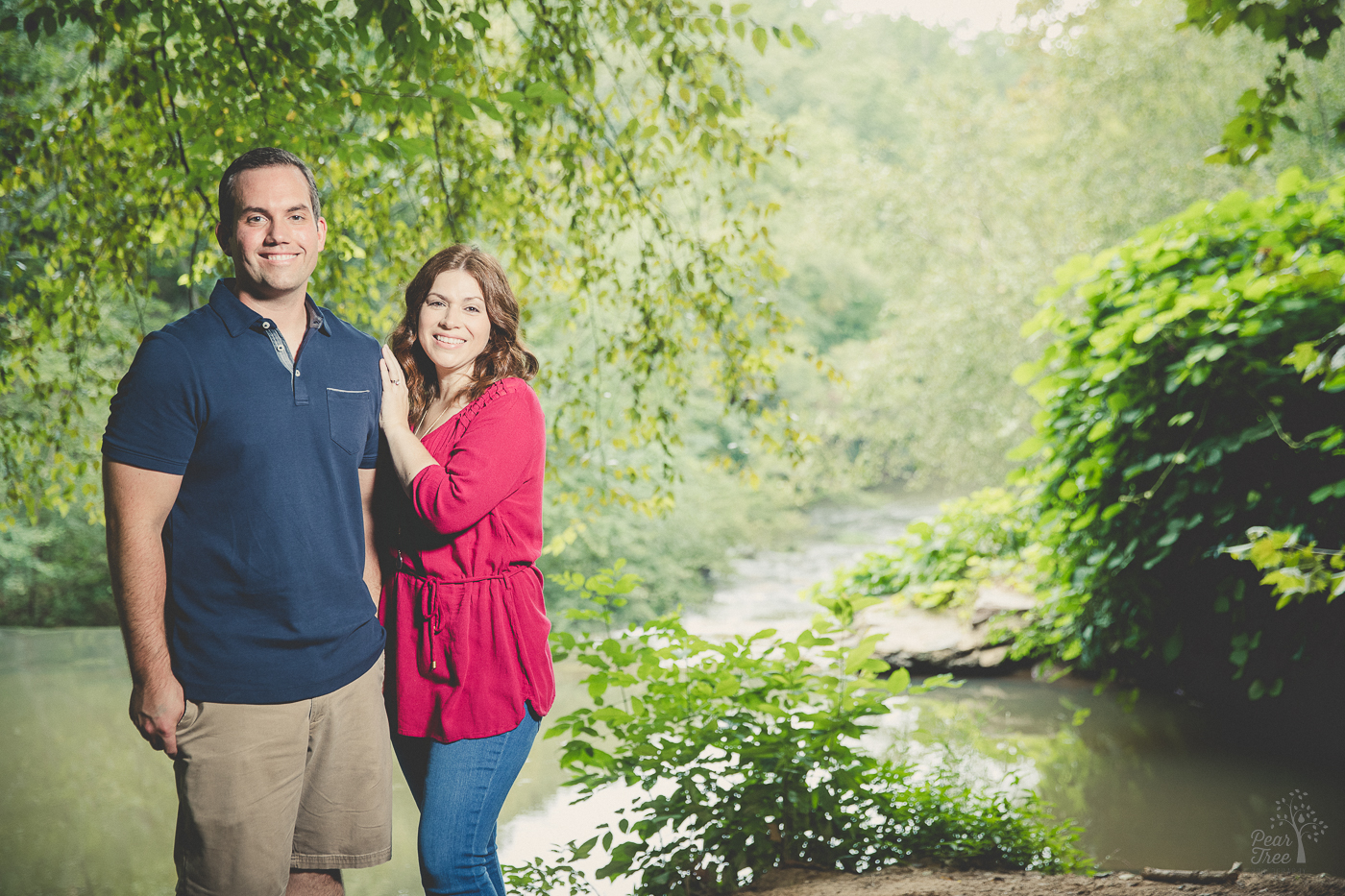 Sweet thirty something couple standing close smiling and happy their daughters cooperated for family photographs at Roswell Mill