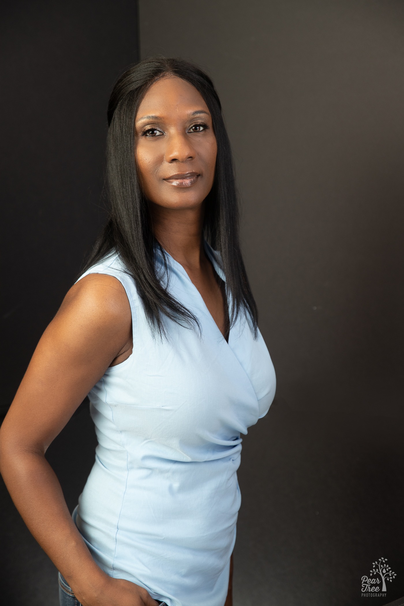 Upper body headshot of smiling African American woman in blue