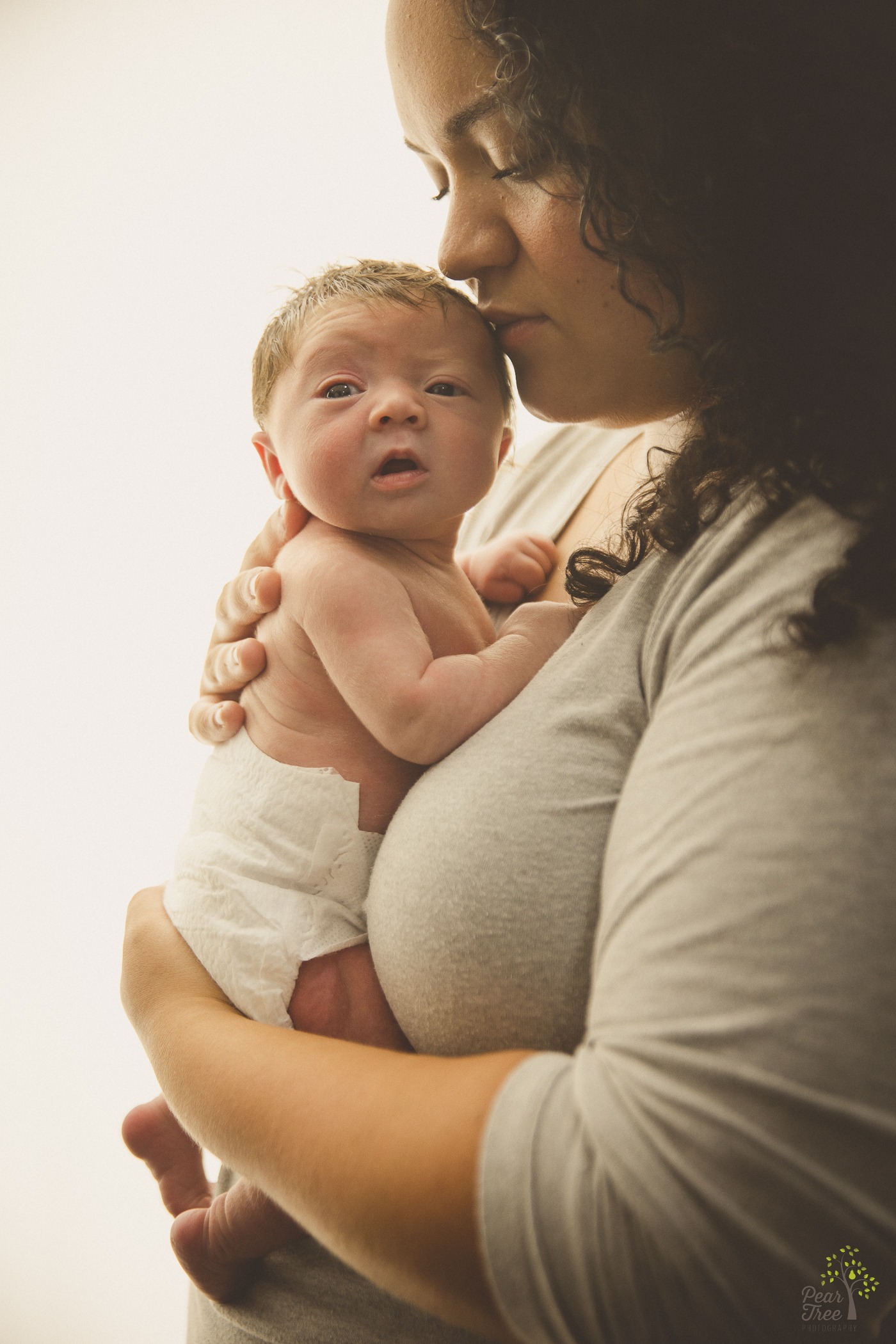 Newborn daughter being held close by her mom