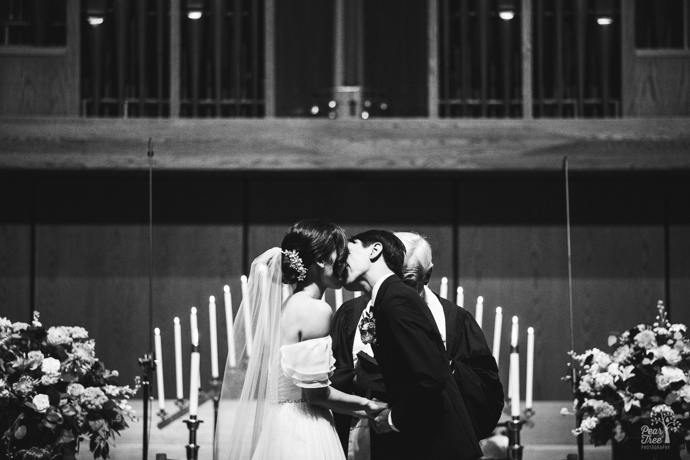Asian wedding couple kissing after being married in Eastminster Presbyterian Church in Stone Mountain