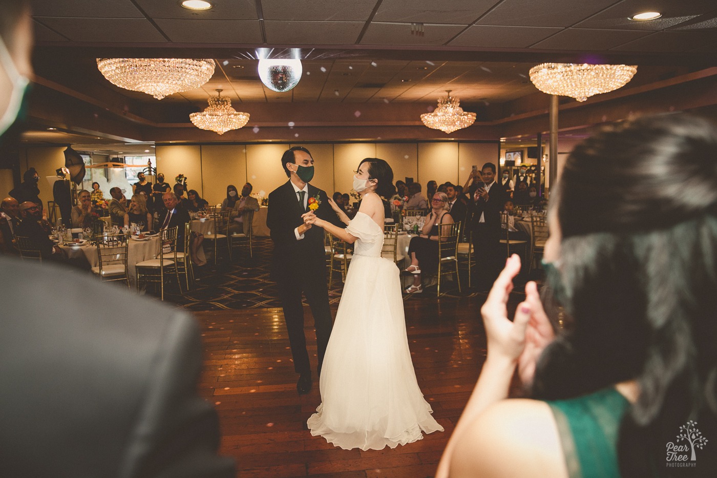 Asian wedding couple dancing and wearing masks at Canton House wedding reception