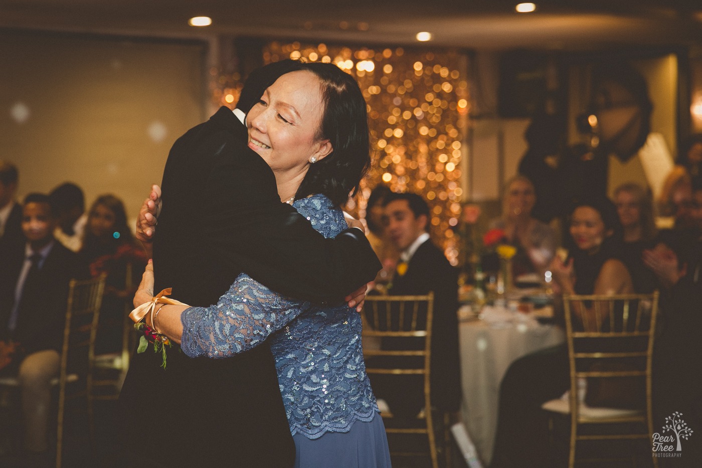 Asian groom hugging his mom after the Mother Son dance