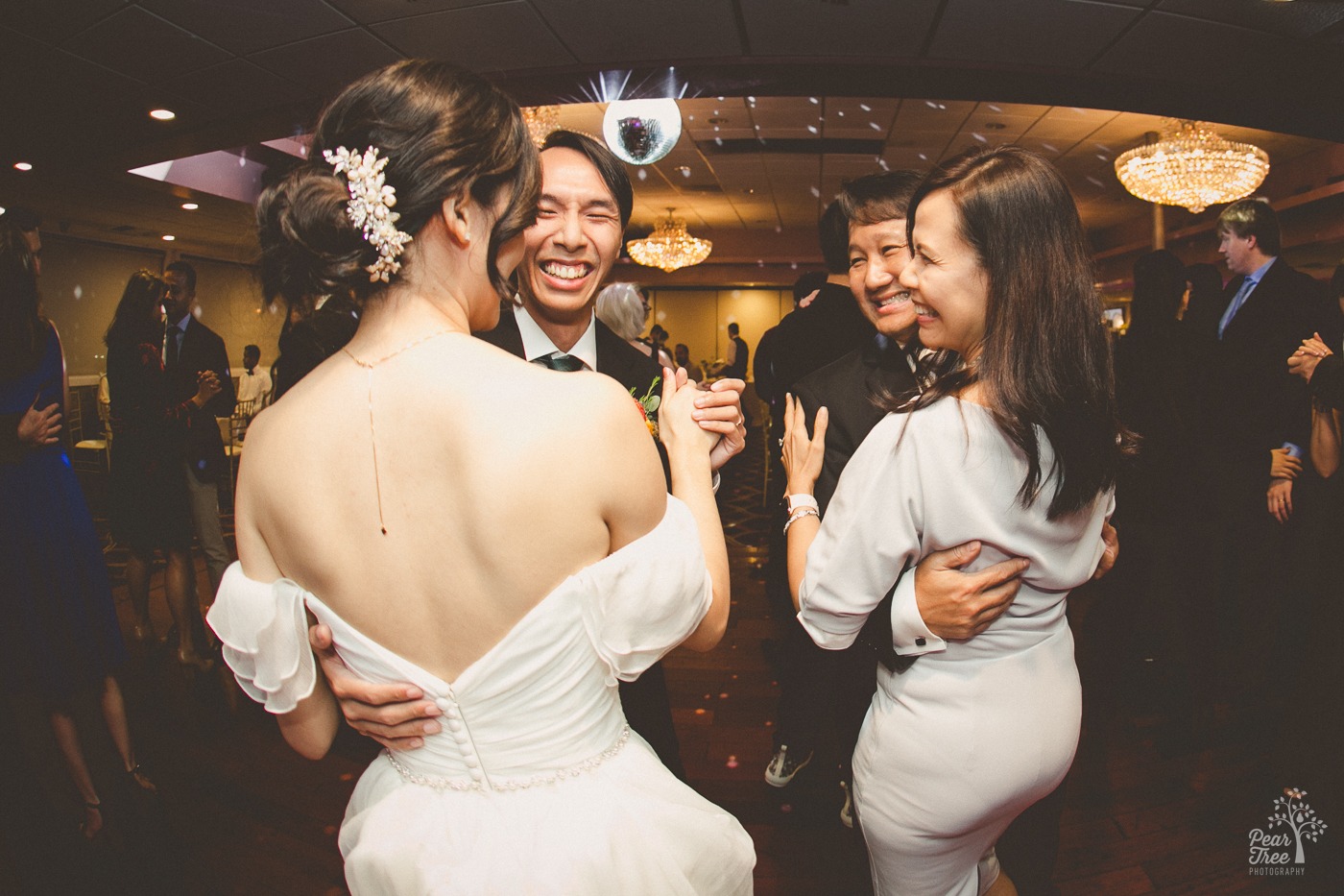 Asian wedding couple dancing next to family members at their Canton House wedding reception