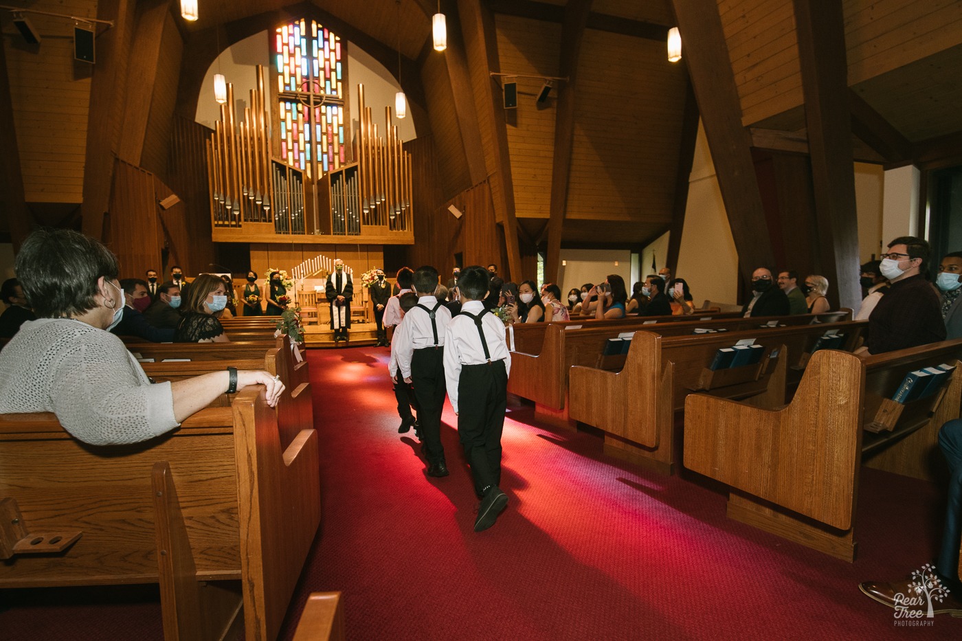 Ring bear Asian boys walking down church aisle in Stone Mountain