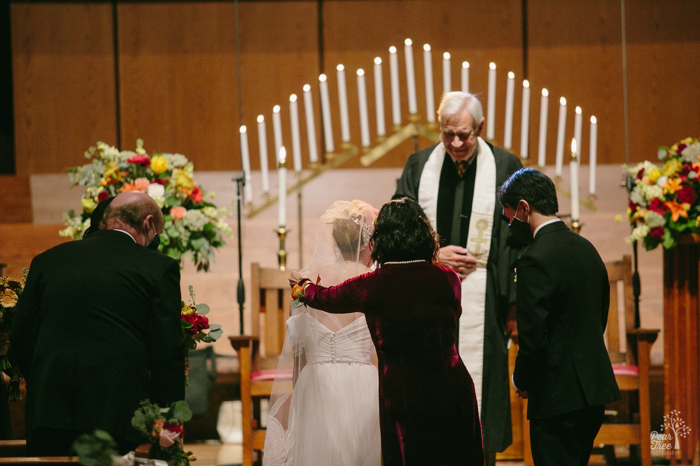 Bride's mom hugging her before sitting down at start of Asian wedding