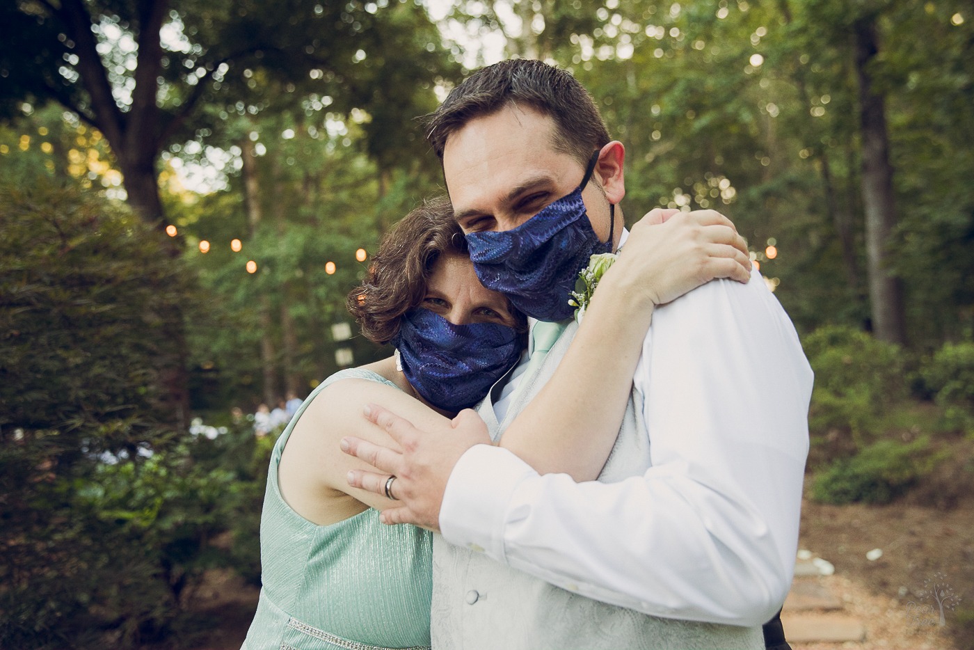 Husband and wife smiling while wearing masks after their wedding ceremony