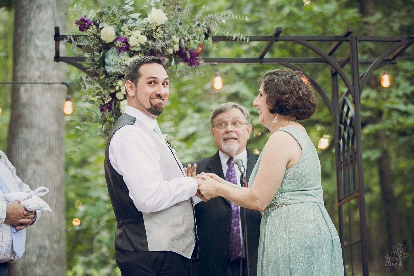 Groom and bride laughing and looking surprised during wedding ceremony