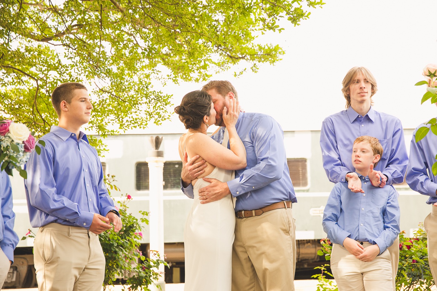 Bride and groom kissing in front of train cars at their Chattanooga Choo Choo Wedding