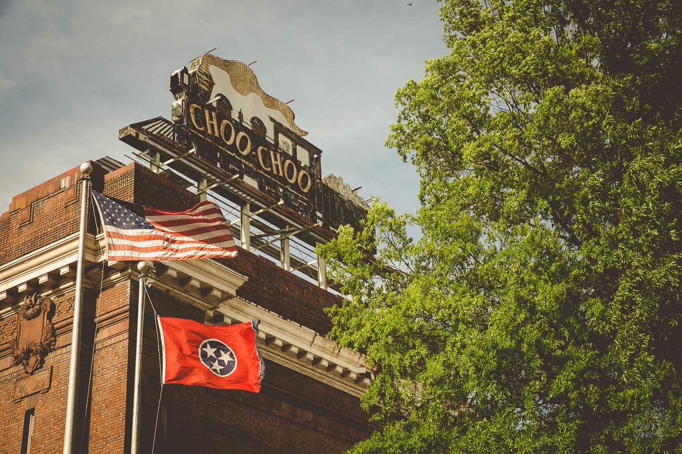 Chattanooga Choo Choo Hotel sign and American flag blowing in the wind