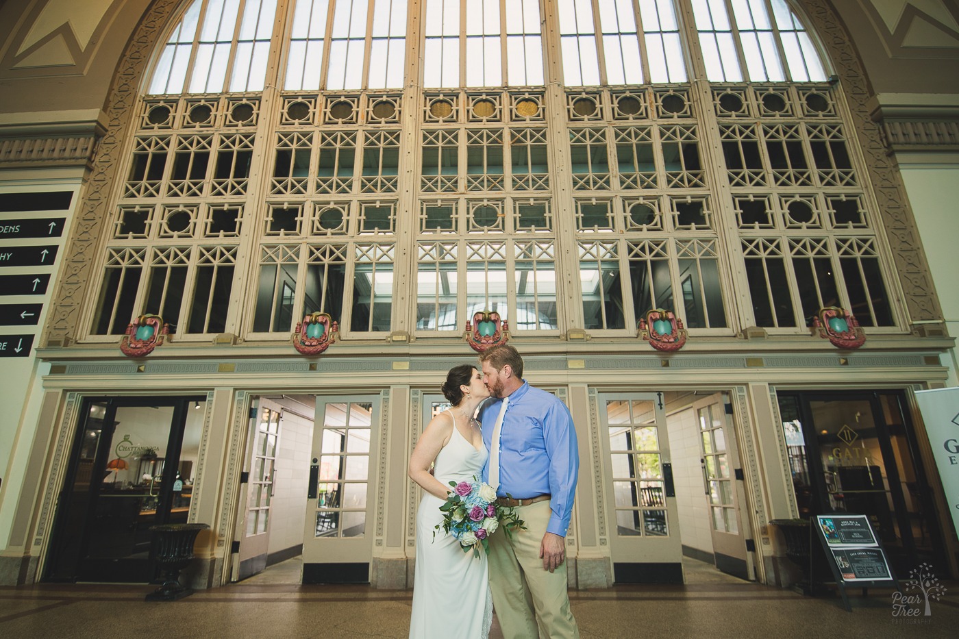 Bride and groom kissing in Chattanooga Choo Choo hotel lobby