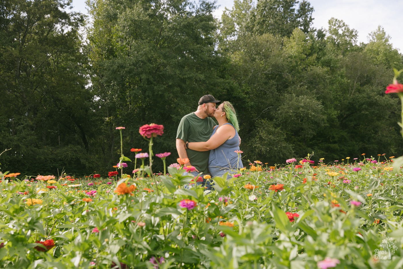 Kissing husband and wife in the middle of Still Family Flower Farm