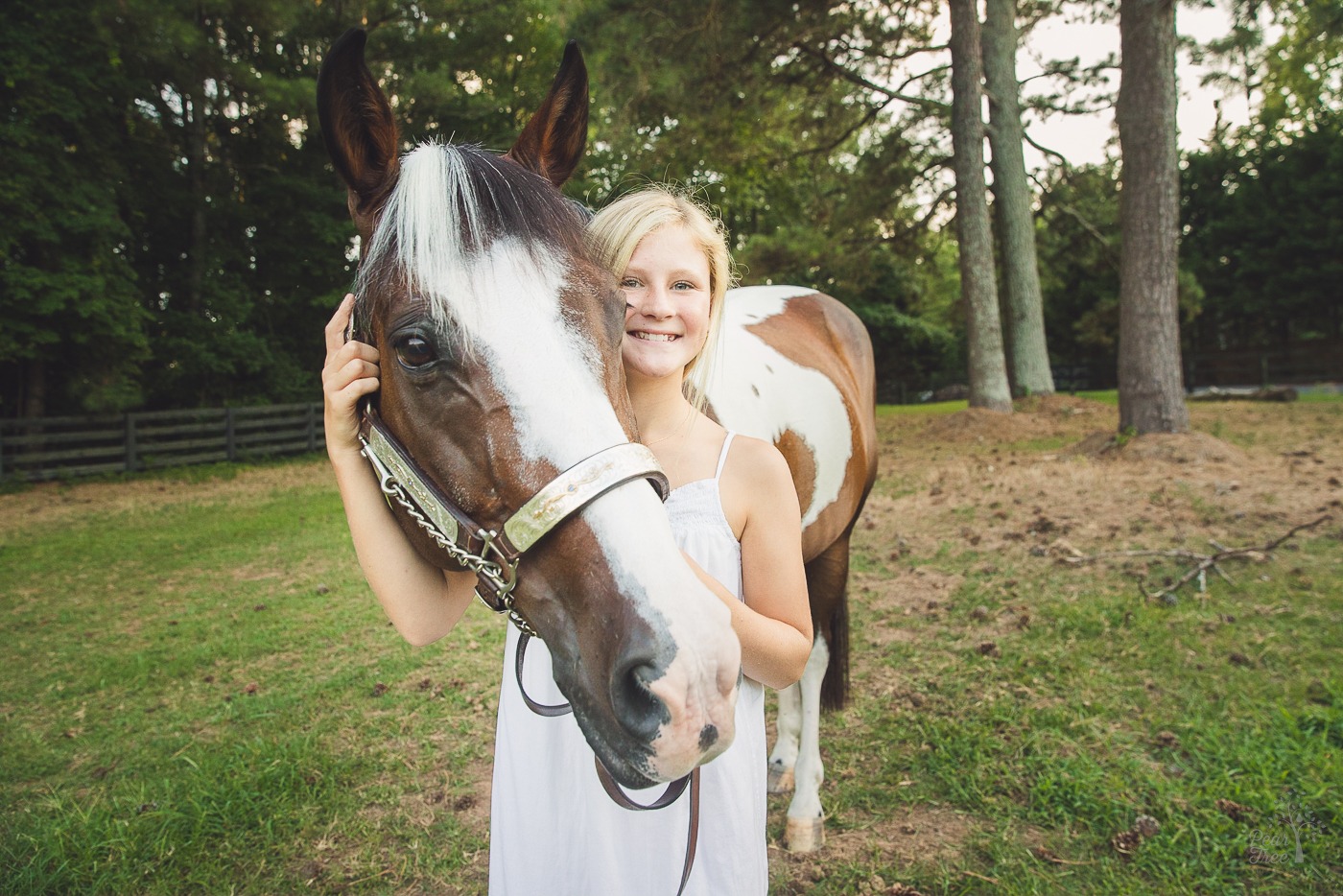 Happy young girl holding her horse by his bridle in a Woodstock, GA pasture