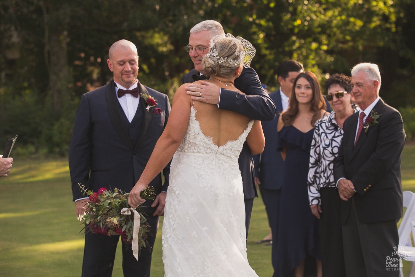 Father hugging his daughter as he gives her away on her wedding day