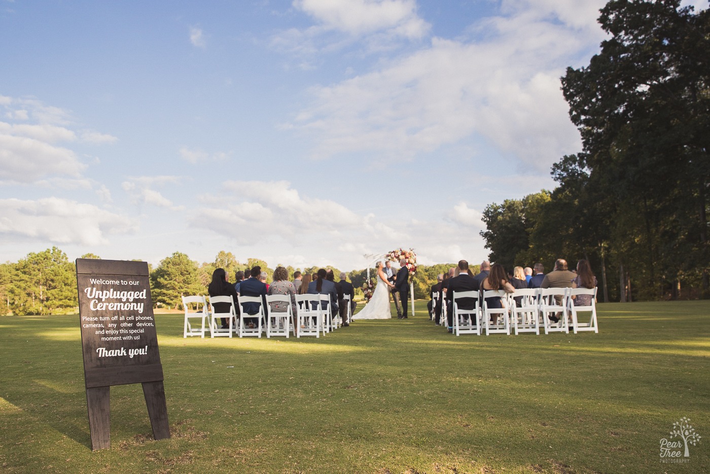 Unplugged ceremony sign at Cumming Polo Fields wedding