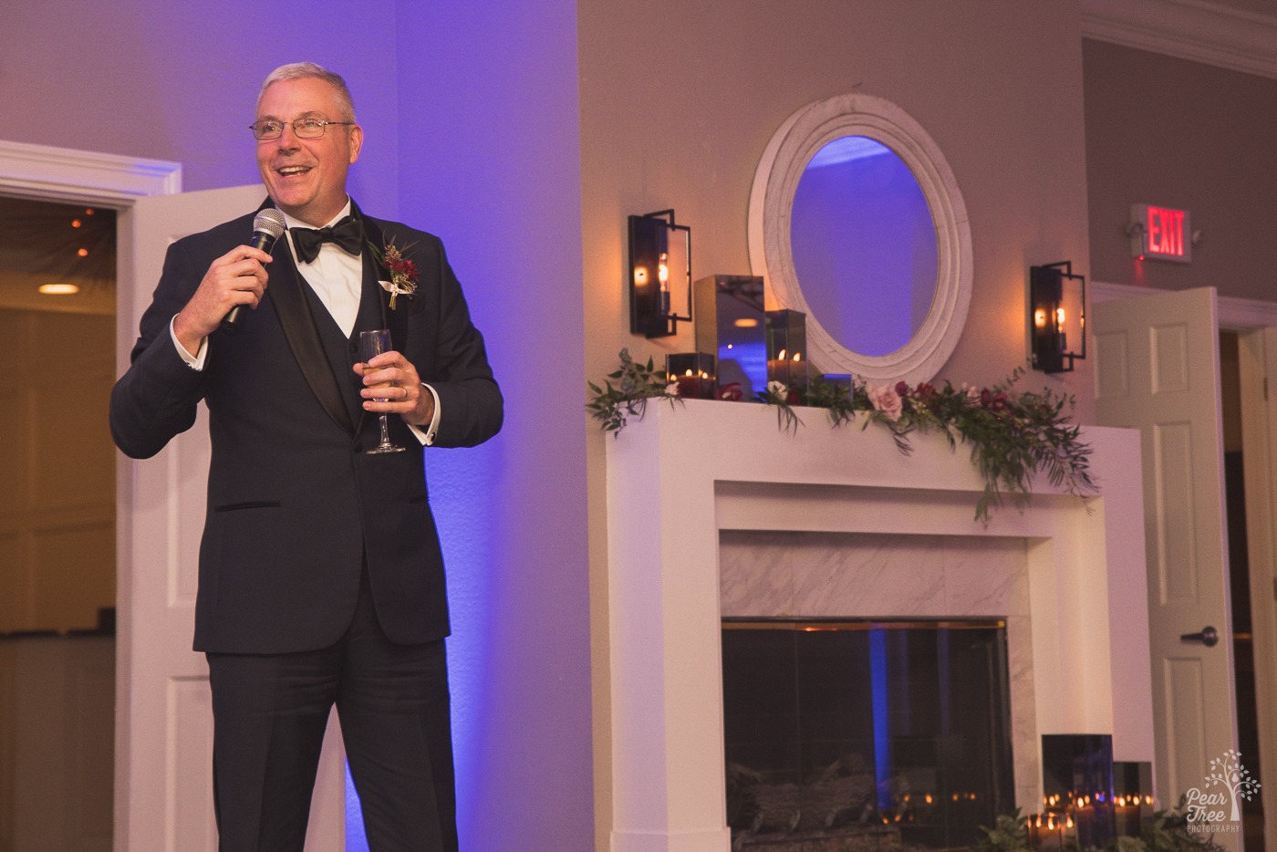 Father of the bride smiling while giving a toast at Cumming Polo Fields