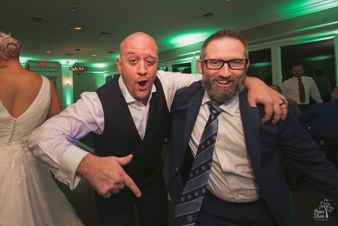 Groom singing and pointing with a friend at Cumming Polo Fields