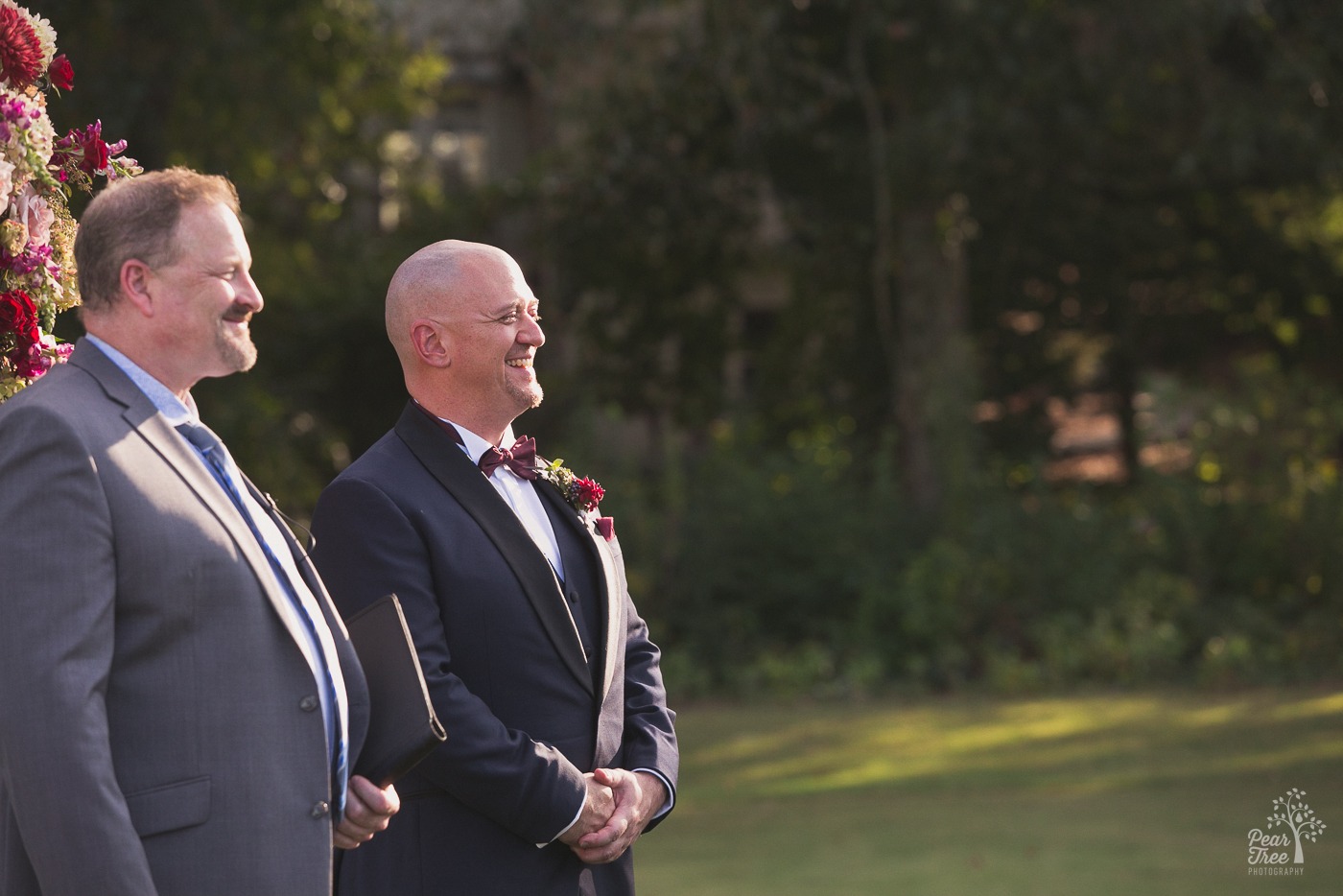 Groom smiling as his bride walks toward him