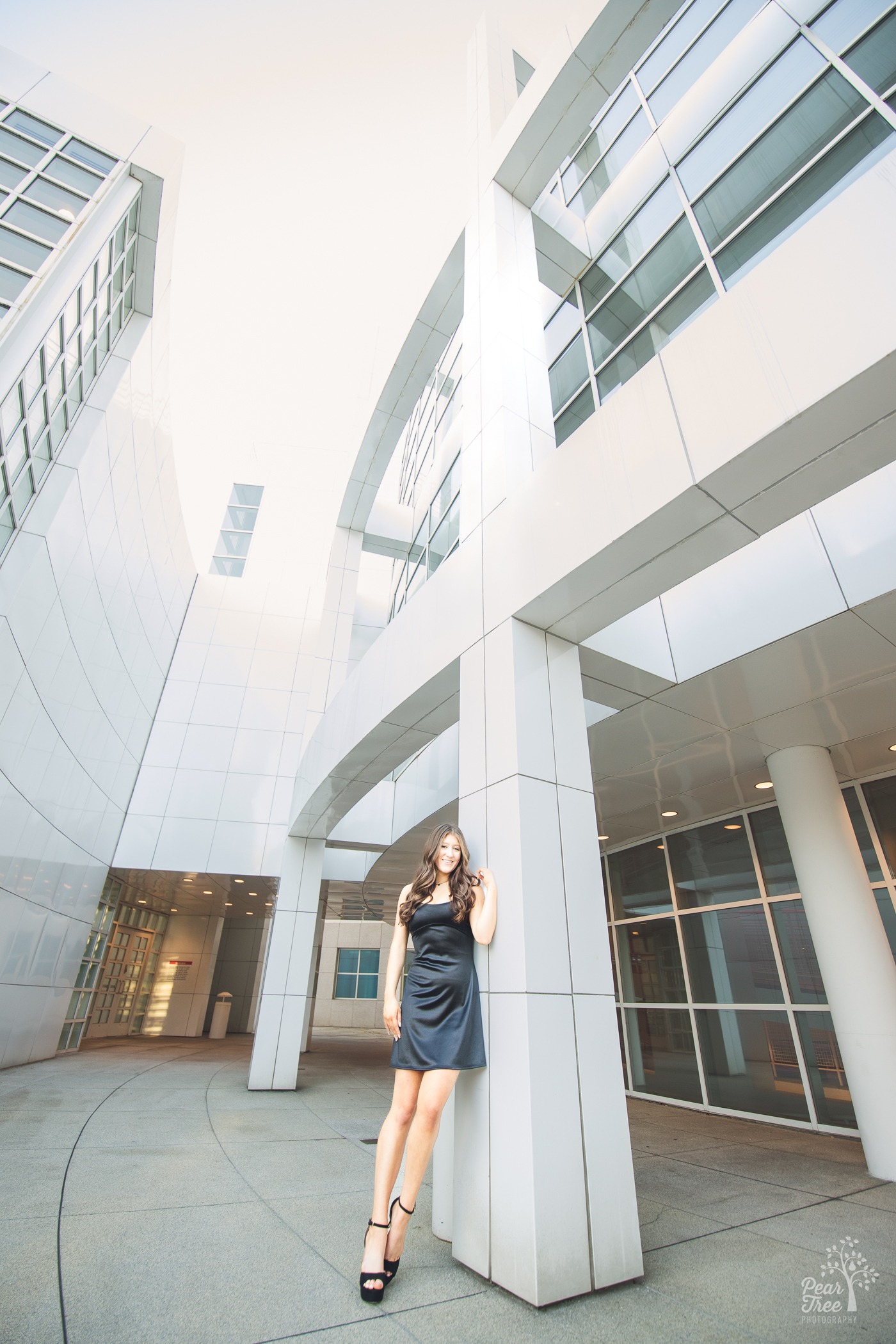 Pretty girl leaning against High Museum of Art building