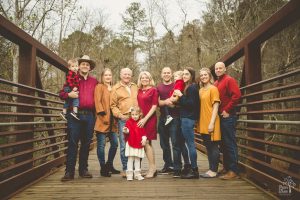 A multi-generational family photo at Olde Rope Mill Park on the metal bridge
