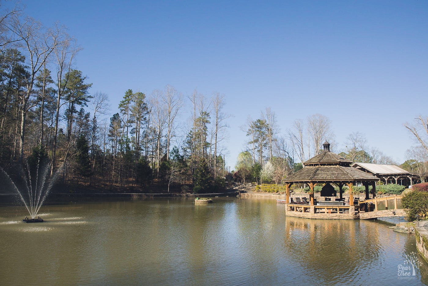Mid day view of Rocky's Lake Estate pond, gazebo, and fountain in Woodstock, GA