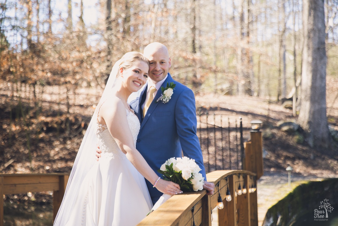 Bride and groom smiling at the camera after their Rocky's Lake Estate wedding ceremony