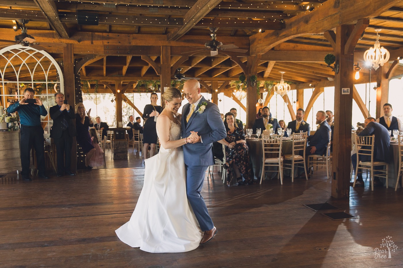 Bride and groom laughing during their first dance