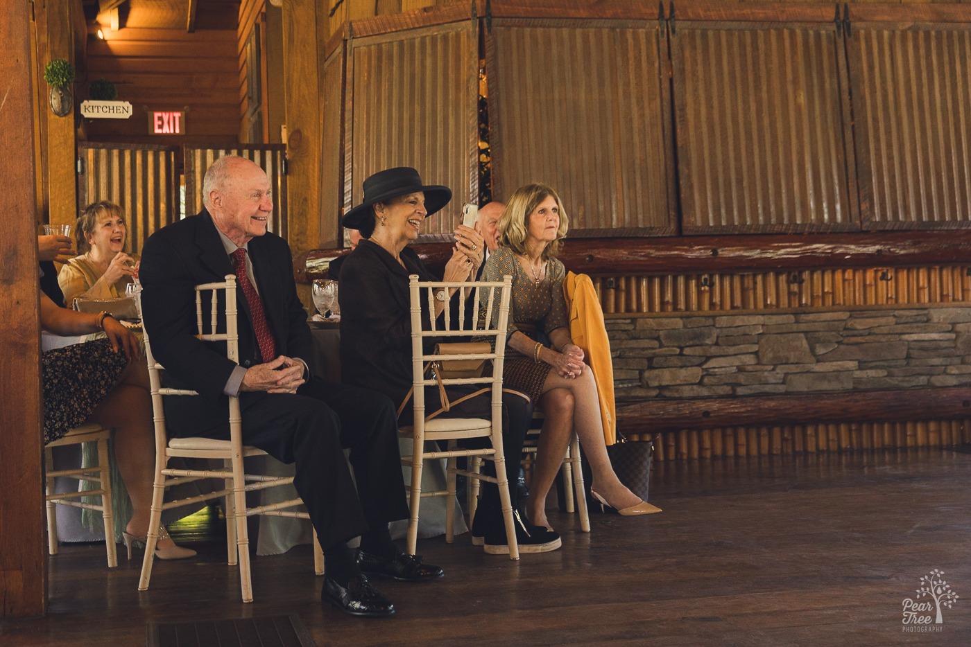 Guests smiling while listening to toasts