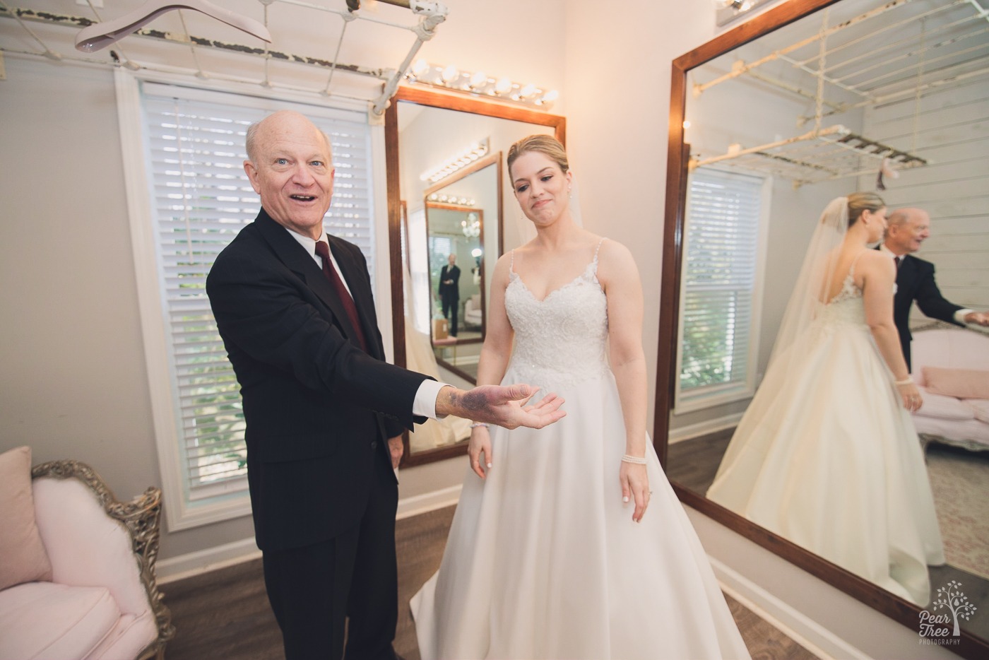 Father of the bride showing his bruised hand from ICU while his daughter looks on thankful he's there