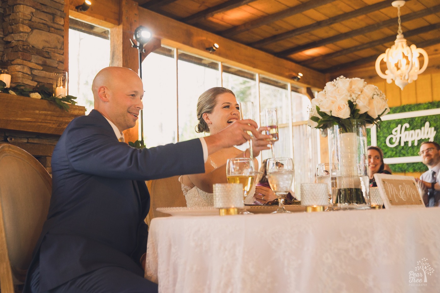 Bride and groom raising their glasses