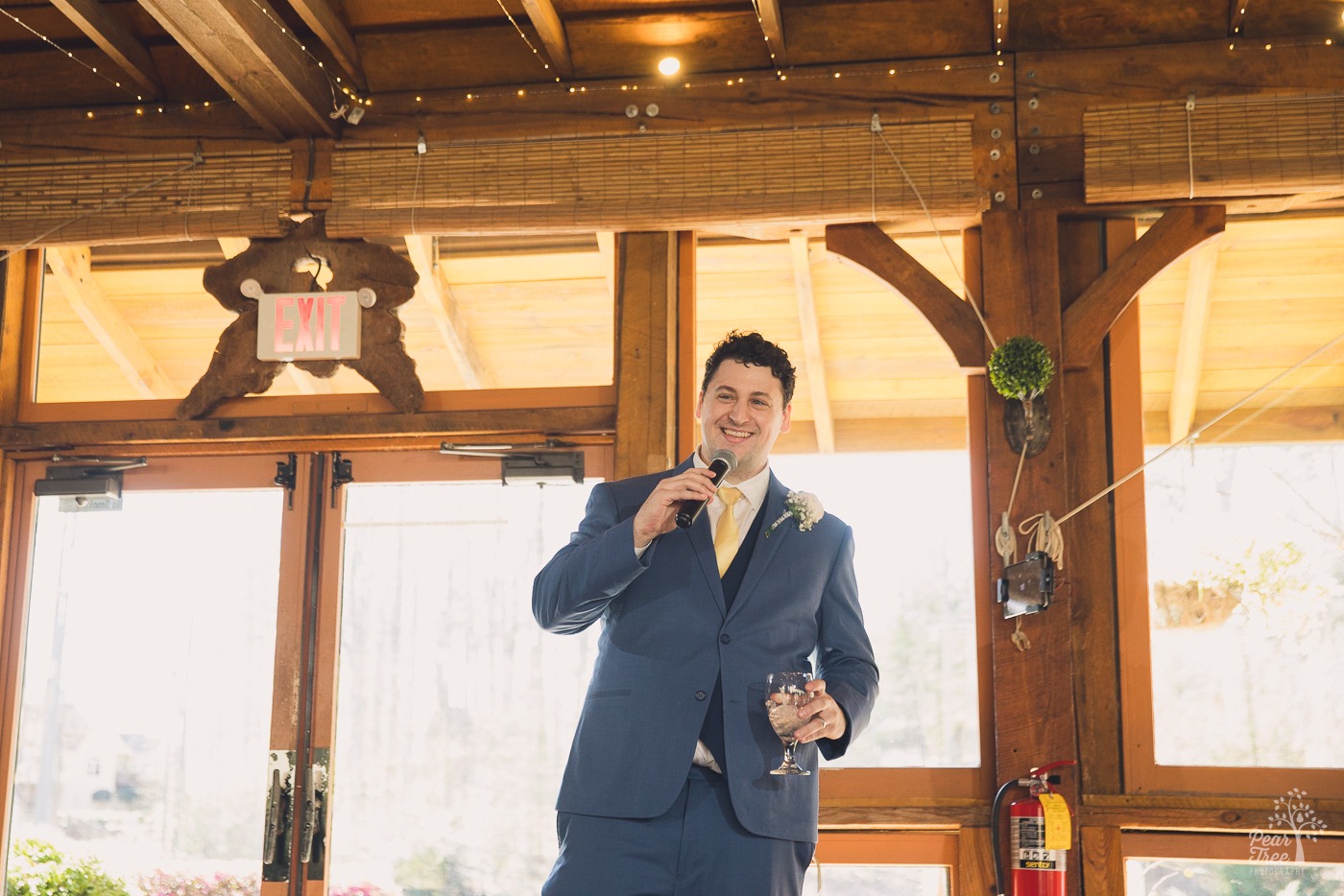 Another brother of the bride giving a toast and smiling
