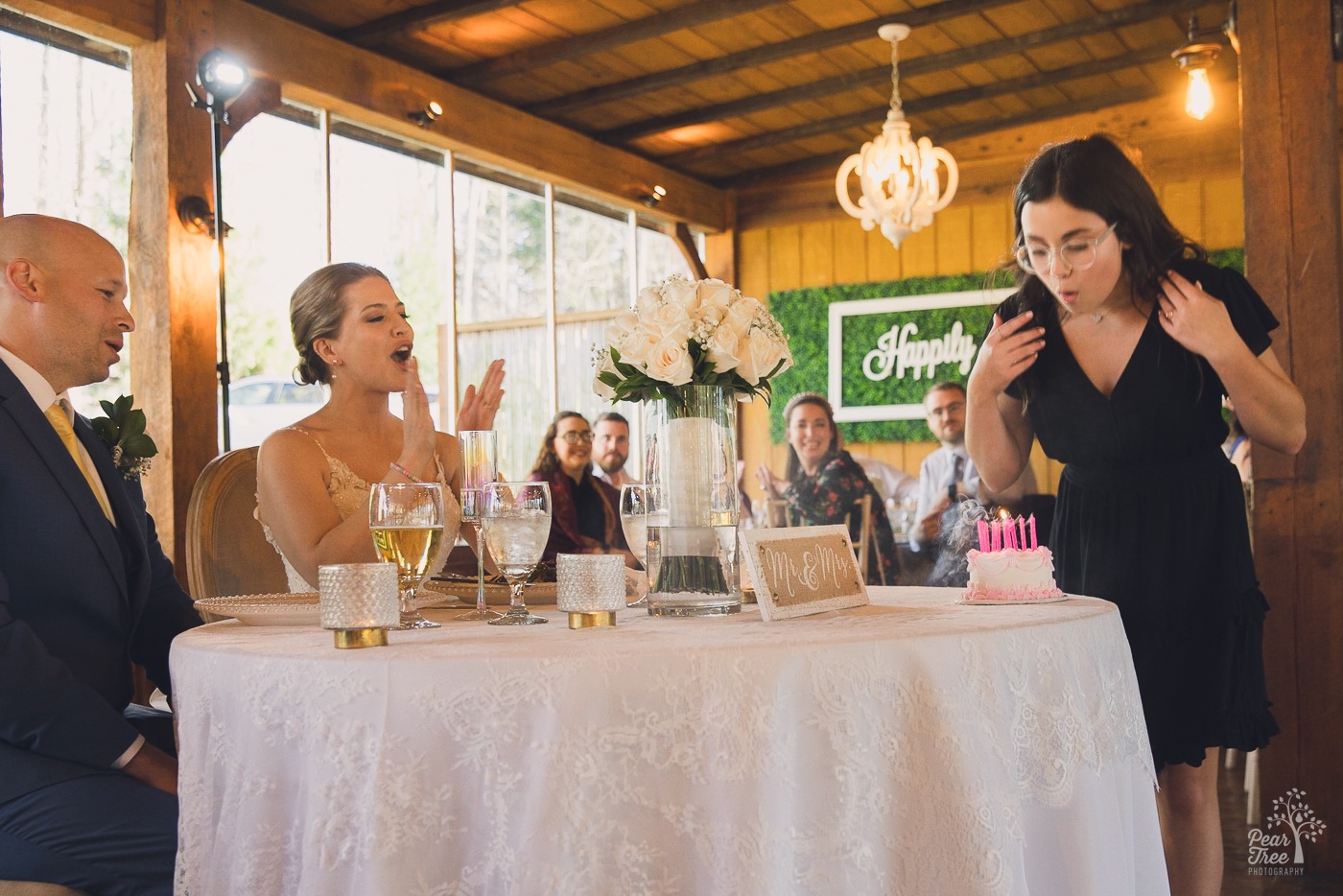 Bride's niece blowing out candles on a little birthday cake