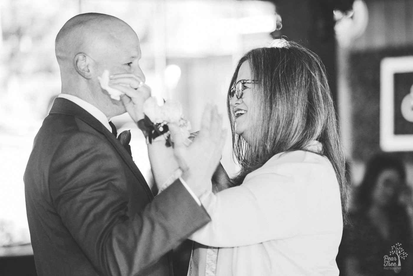 Mom wiping her son's tears before their Mother Son dance