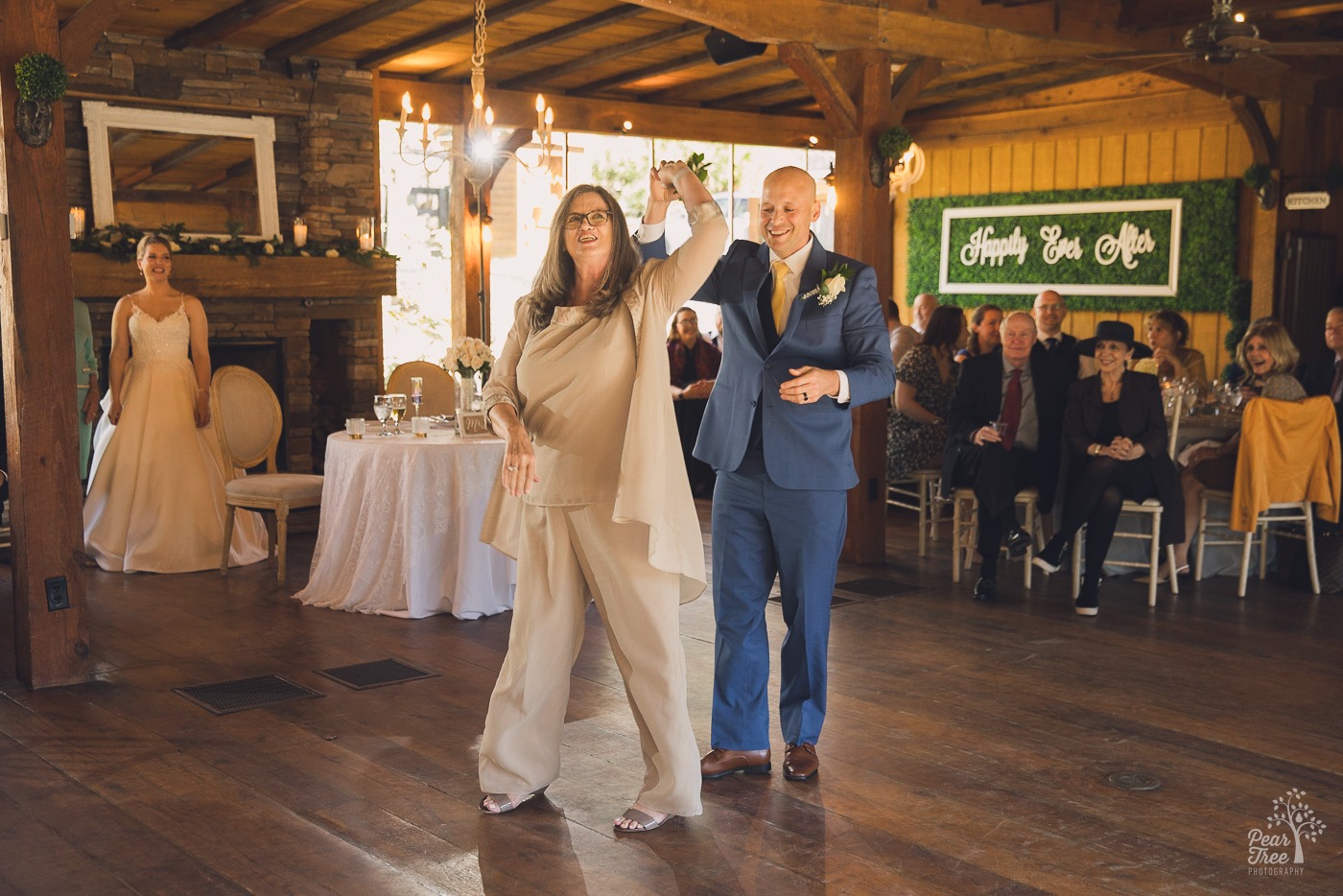 Groom spinning his mom during their dance at his wedding