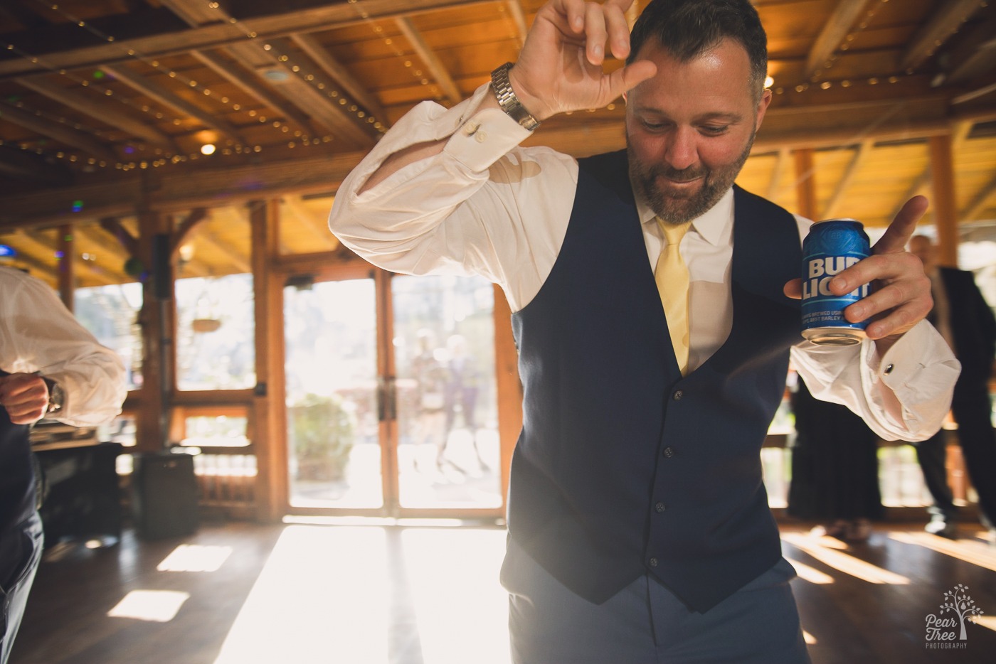 Groomsman dancing with a Bud Light can in hand
