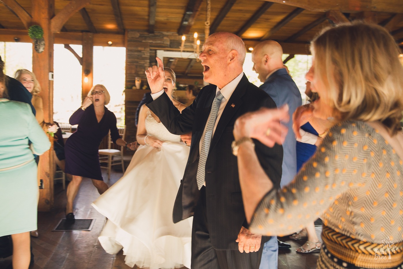 Wedding guests singing on the dance floor while dancing