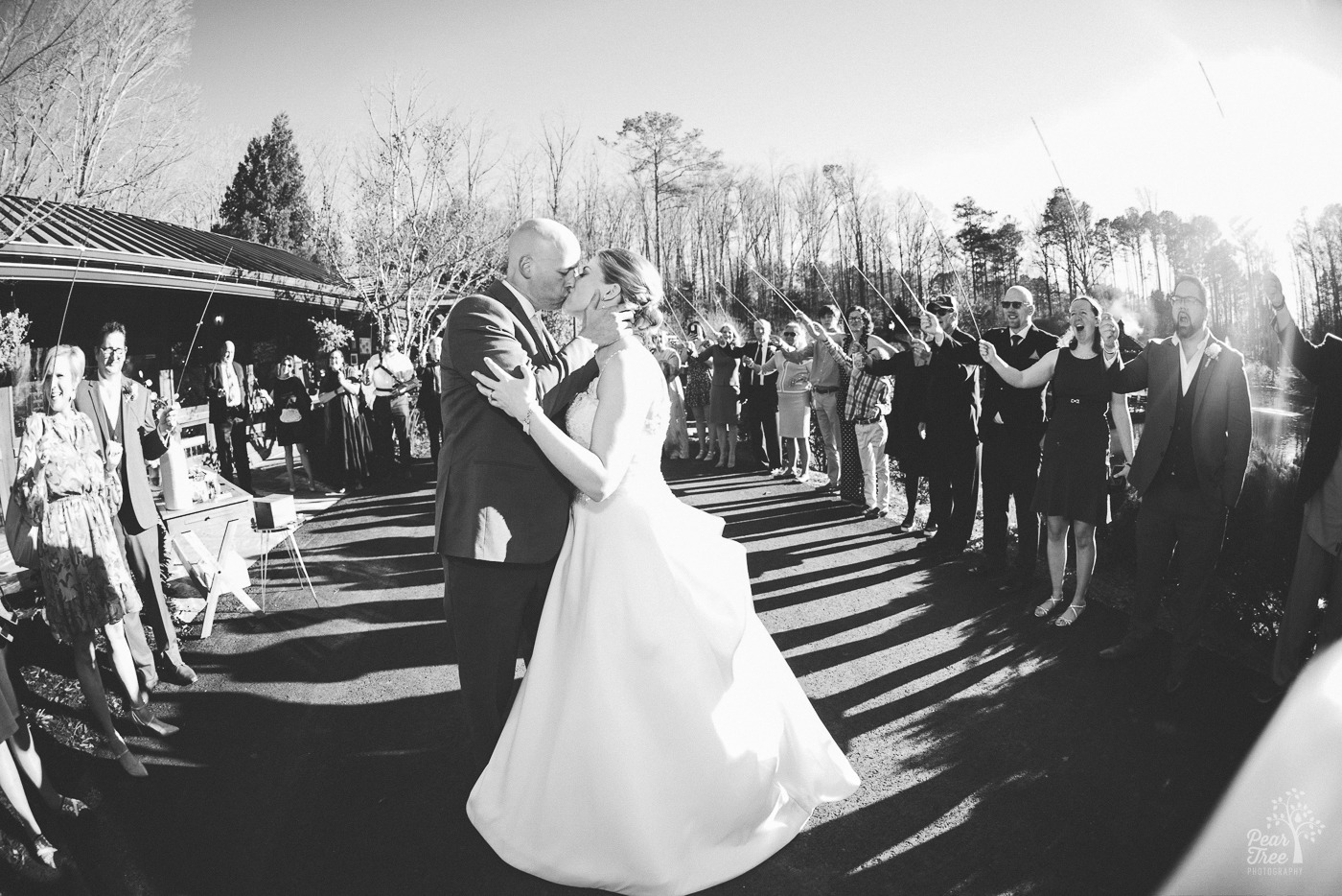 Black and white photo of bride and groom kissing at Rocky's Lake Estate wedding