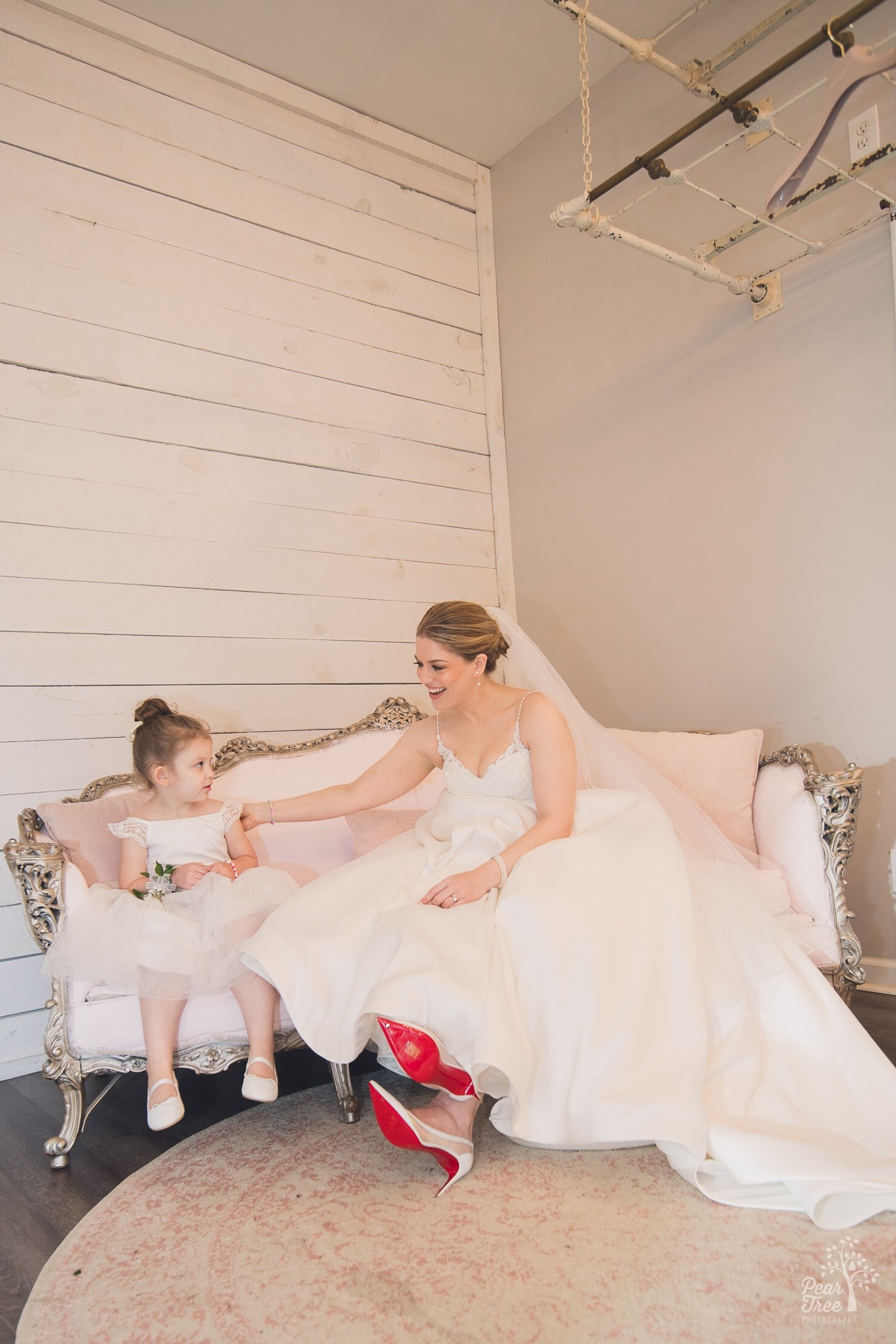 Bride in Louboutin shoes hanging out with her niece before her wedding at Rocky's Lake Estate in Woodstock, GA