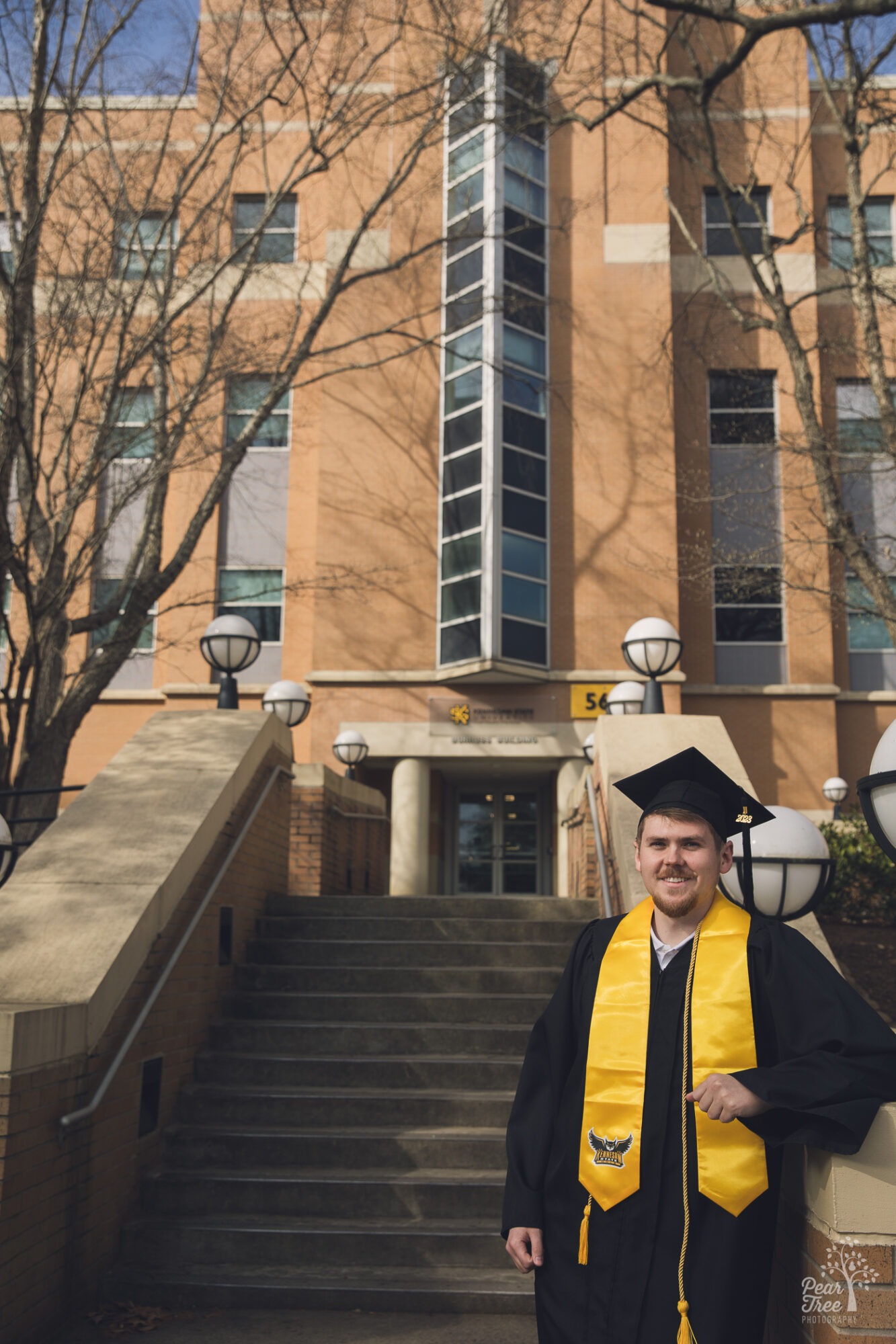 KSU 2023 business school graduate taking graduation photos