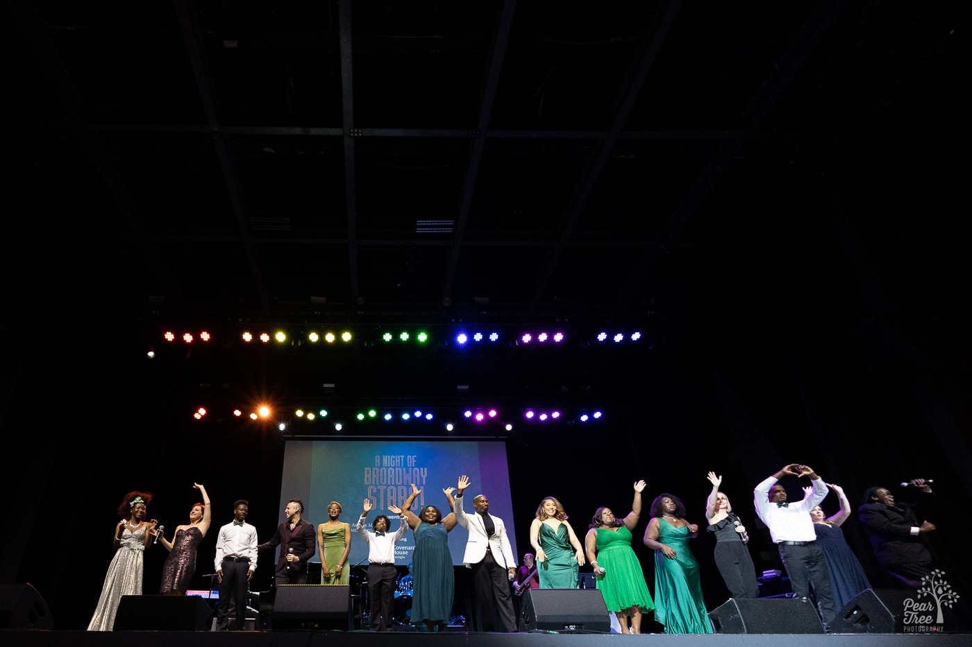 Covenant House Georgia youth and broadway stars waving to thee audience at the Coca Cola Roxy