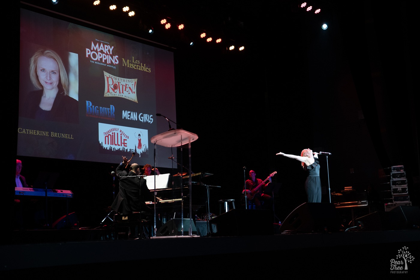 Broadway Star Catherine Brunell ending her performance on stage with her head back and arms outstretched