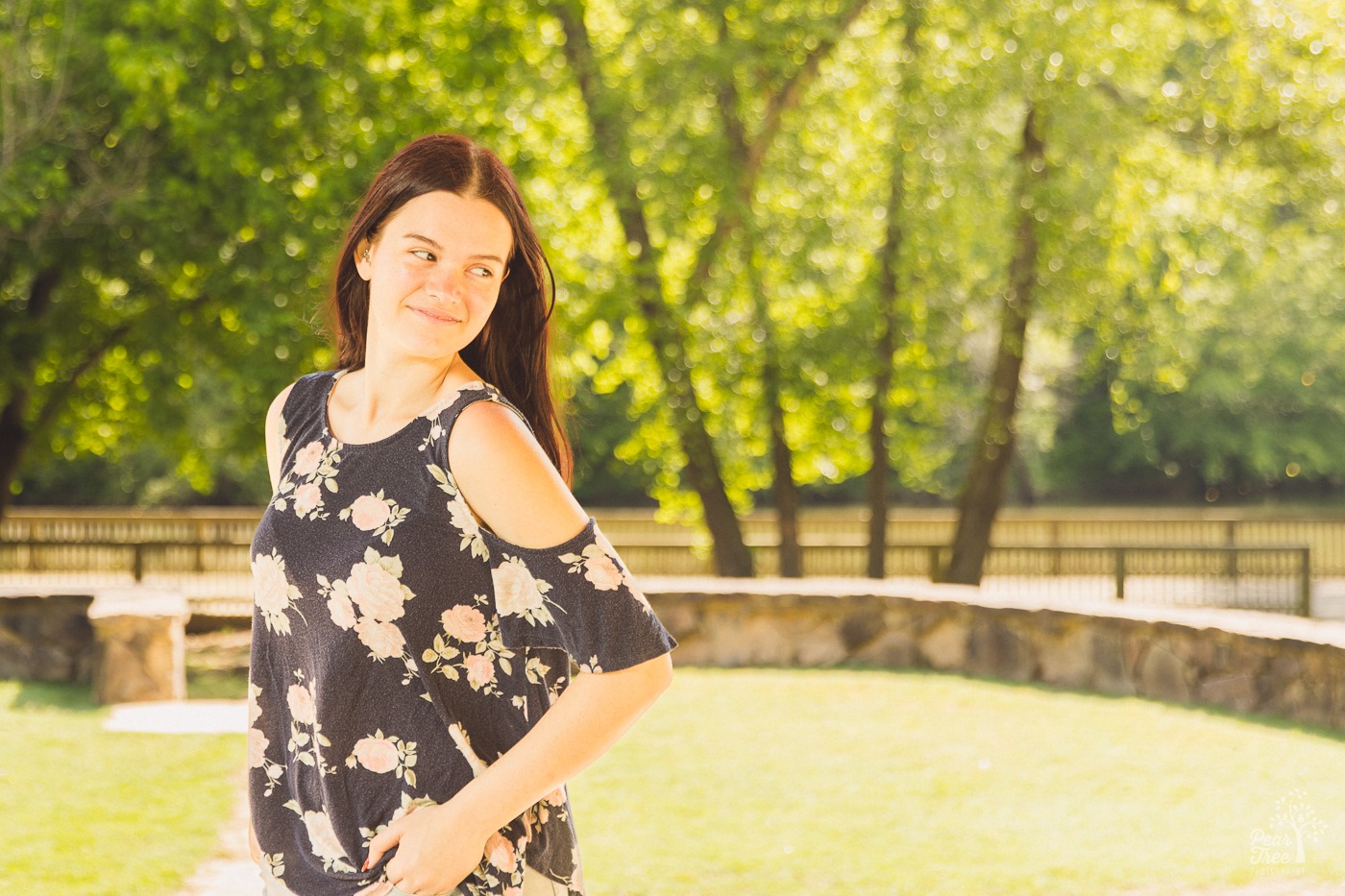 Gorgeous high school senior looking over her shoulder with Little River in the background at Olde Rope Mill Park