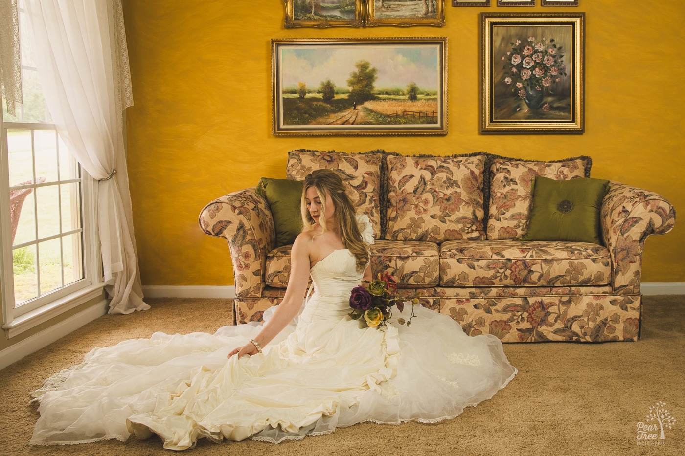 Alley Bei wearing her original wedding dress and holding her dried bouquet